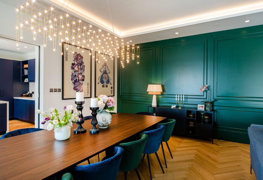 Villa Laura dining room by Smart Renovation following principles of lighting in interior design for ambient room lights and natural light.