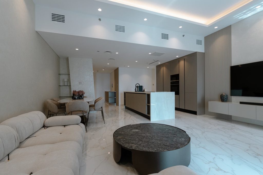The Golden Crocodile Cayan Tower 4103 showcases effective space planning in an open-plan kitchen, dining, and living area.